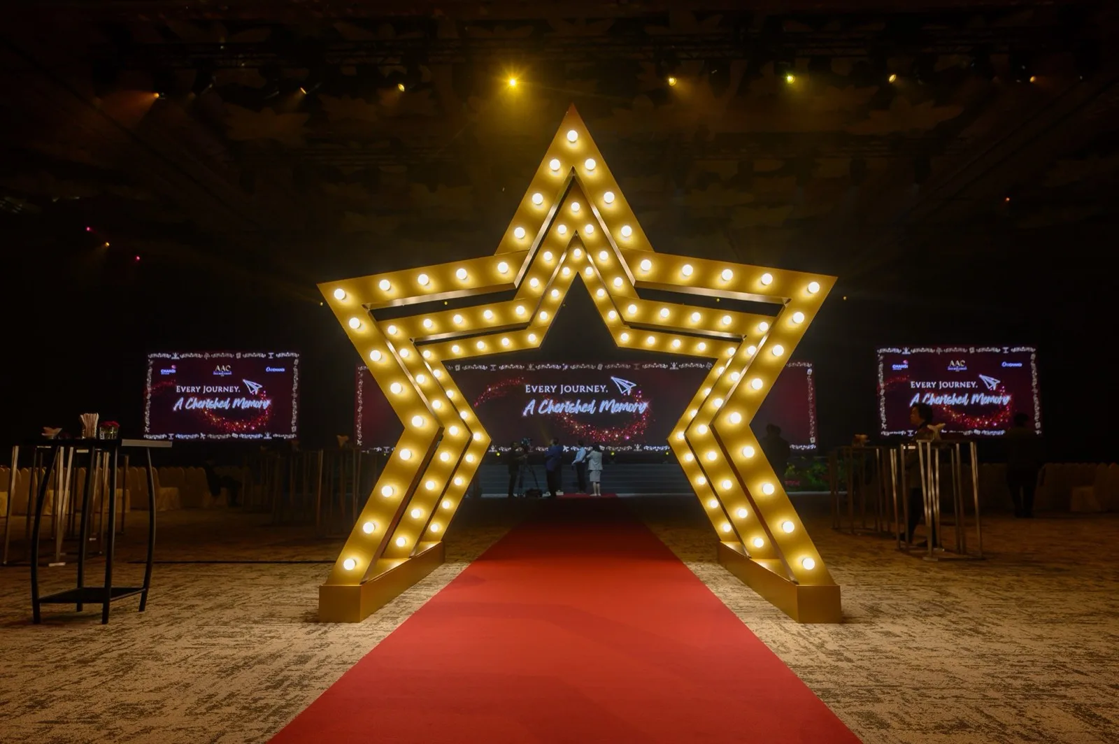 Illuminated star entrance framing the celebration stage
