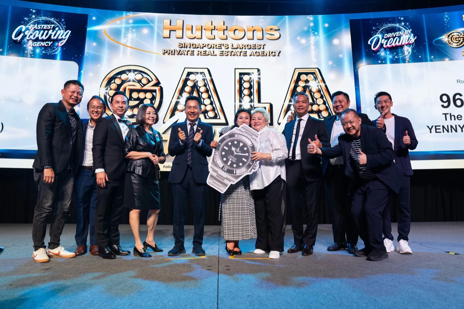 Huttons award recipients celebrating on stage