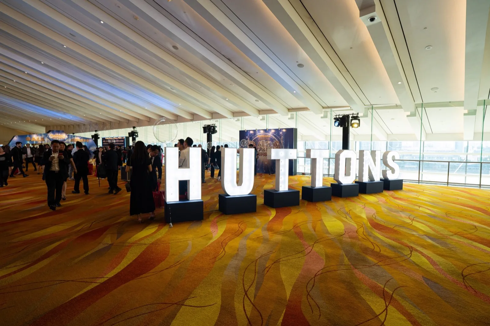 Illuminated Huttons letter installation in the convention foyer