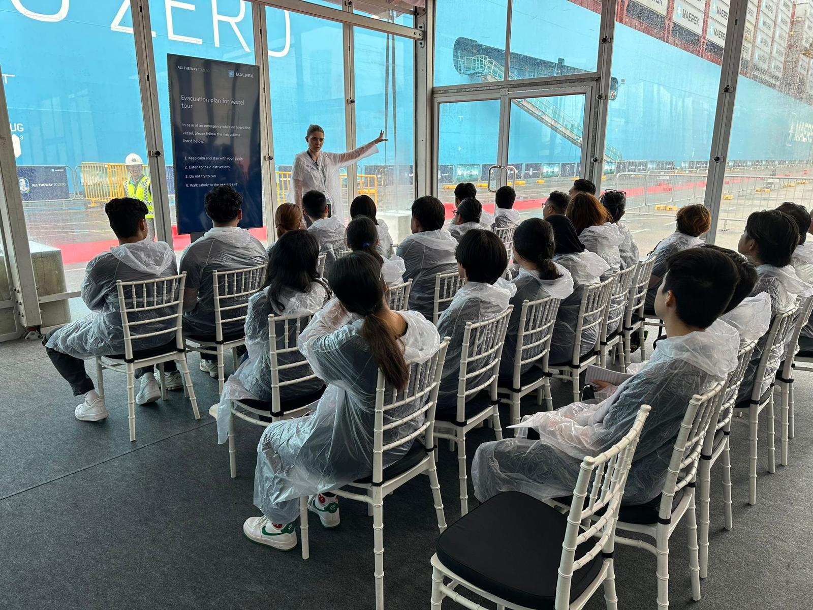Maersk team briefing beside the vessel