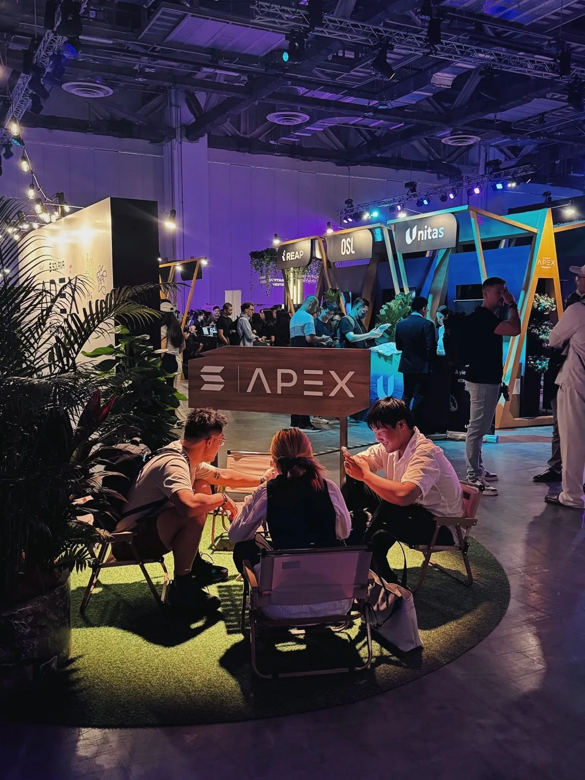 Guests connecting beside the Solana Apex sponsor booths